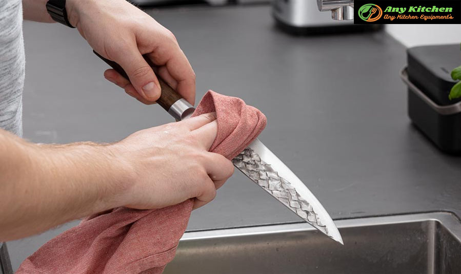 When must a knife be cleaned and sanitized